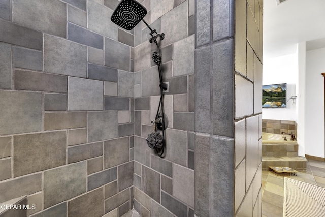 bathroom featuring tiled shower and a garden tub