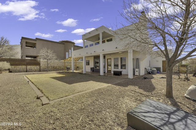 back of house featuring a patio, stucco siding, central AC unit, fence, and ceiling fan