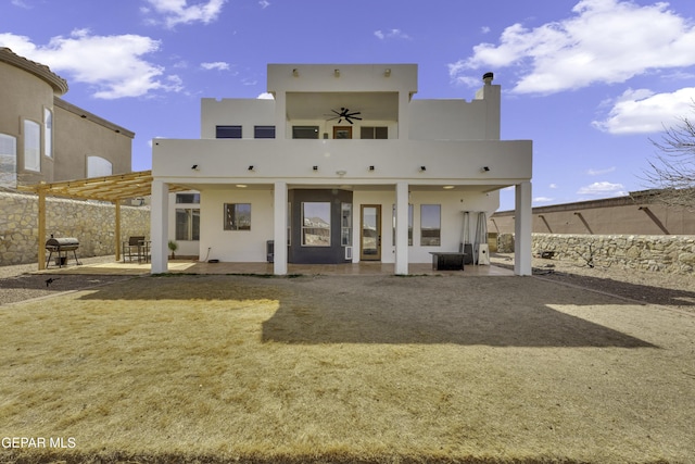 back of property featuring a patio and stucco siding