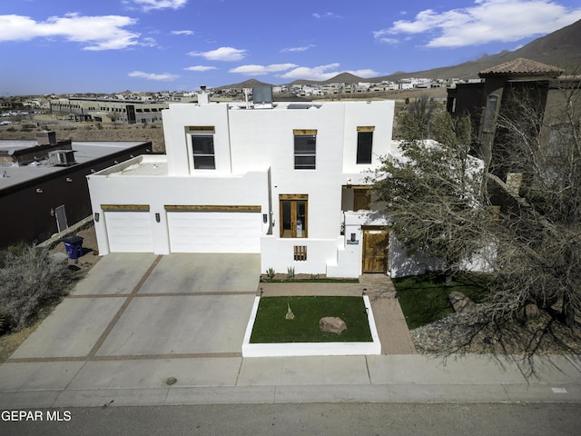 view of front of house with driveway and stucco siding