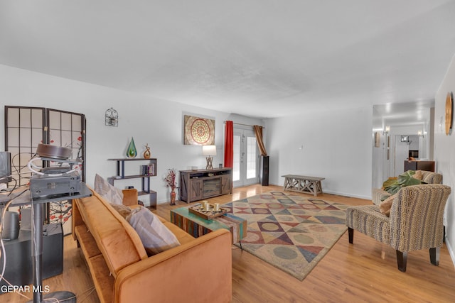 living area with wood finished floors and baseboards