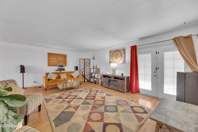 living room featuring french doors and light wood finished floors