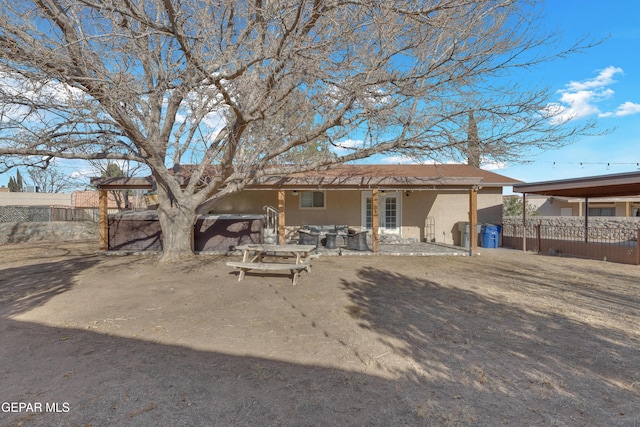 back of property featuring stucco siding, a patio, and fence