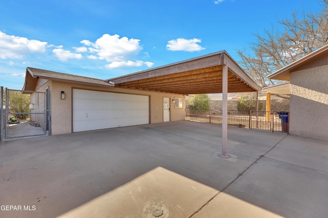 exterior space featuring a garage, fence, and a gate