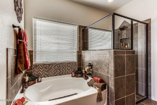 full bath with a stall shower and a garden tub