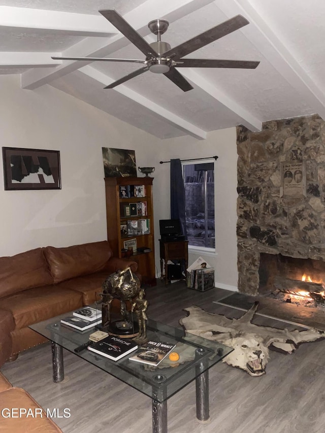 living area with a fireplace, lofted ceiling with beams, a ceiling fan, and wood finished floors