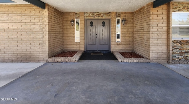 doorway to property with brick siding