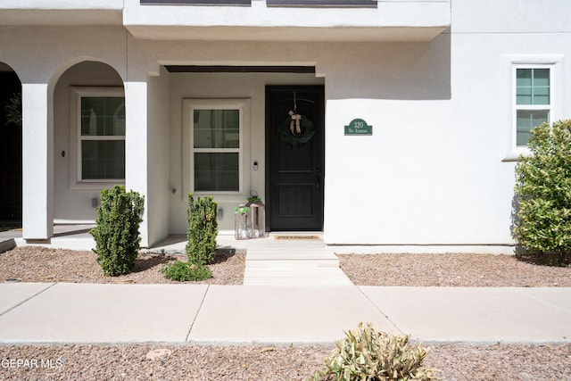 property entrance with stucco siding