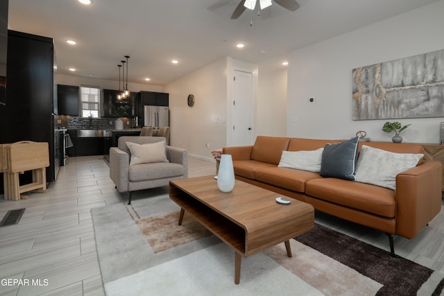 living area with ceiling fan, visible vents, baseboards, and recessed lighting