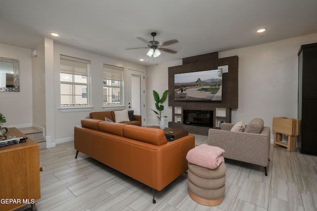 living area featuring recessed lighting, a fireplace, a ceiling fan, and baseboards