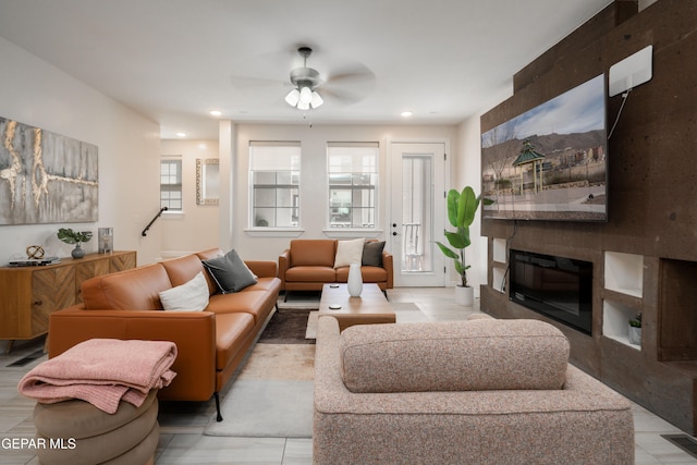 living area featuring a fireplace, visible vents, a ceiling fan, and recessed lighting