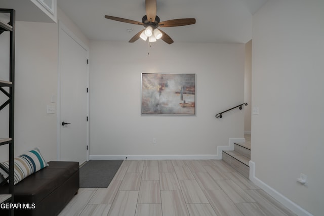 interior space featuring ceiling fan and baseboards