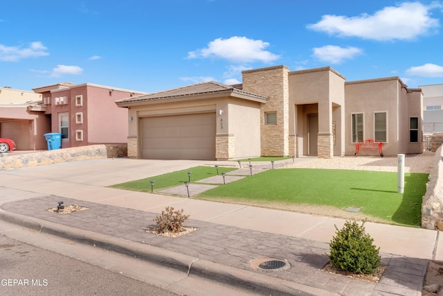 pueblo-style home featuring a garage, stone siding, concrete driveway, stucco siding, and a front lawn