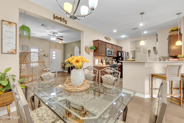 dining room with baseboards, visible vents, a ceiling fan, and recessed lighting