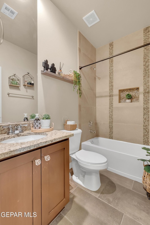 bathroom with washtub / shower combination, visible vents, vanity, and toilet