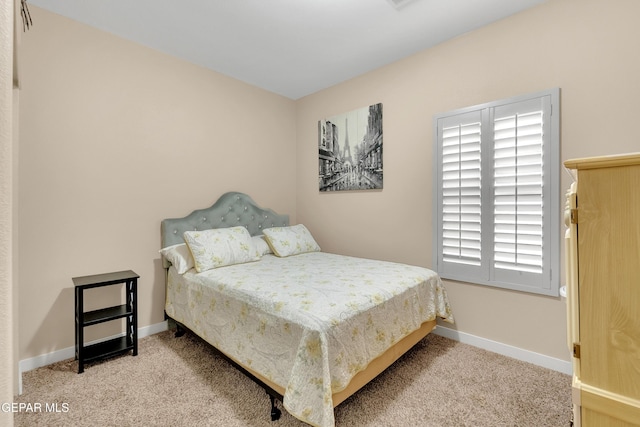 bedroom with carpet flooring and baseboards