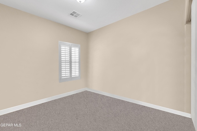 carpeted empty room with baseboards and visible vents