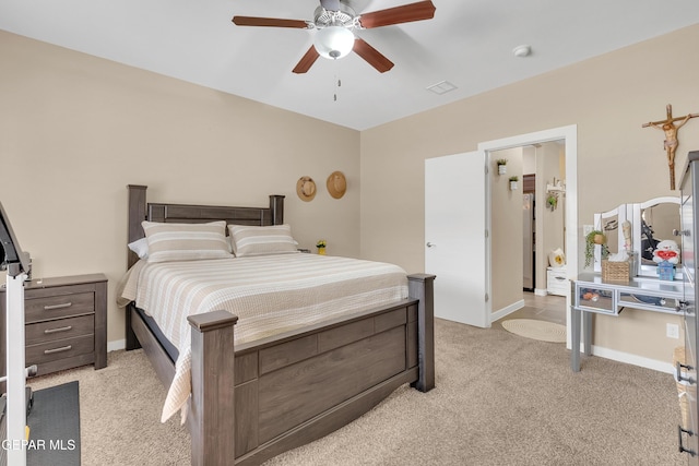 bedroom with ceiling fan, baseboards, and light colored carpet