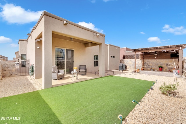 rear view of house with a patio, fence, a gate, and stucco siding