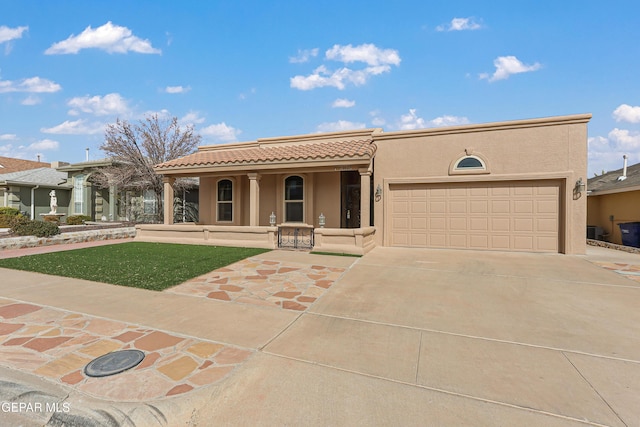 view of front of house featuring stucco siding, a porch, concrete driveway, an attached garage, and a tiled roof