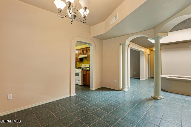 unfurnished room with visible vents, arched walkways, baseboards, and ornate columns