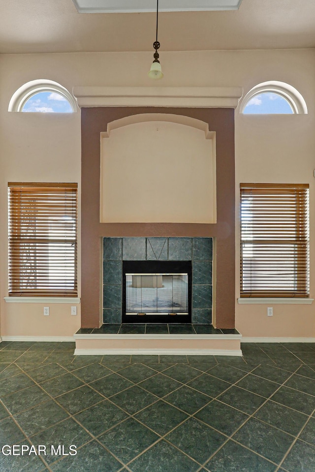 details featuring baseboards and a tile fireplace