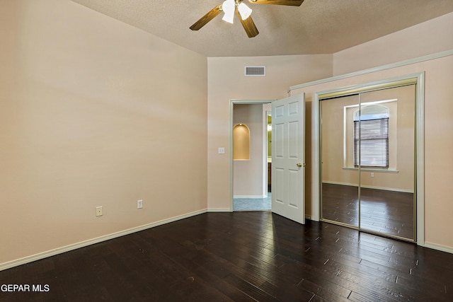 unfurnished bedroom with visible vents, ceiling fan, baseboards, hardwood / wood-style flooring, and a closet