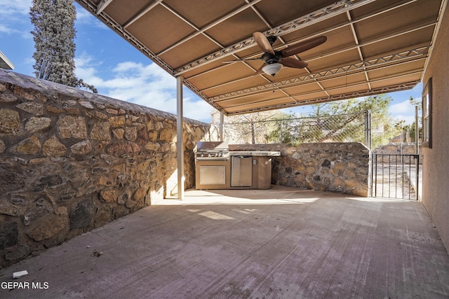 view of patio / terrace featuring a gate, a grill, exterior kitchen, and fence