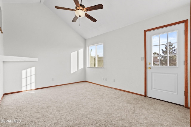 carpeted empty room featuring baseboards, a ceiling fan, and vaulted ceiling