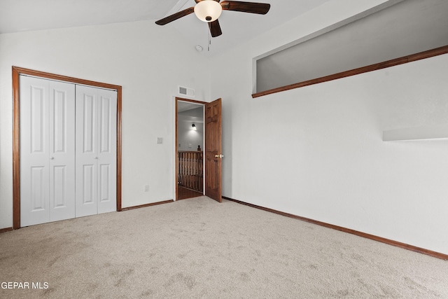 unfurnished bedroom with a ceiling fan, visible vents, vaulted ceiling, a closet, and carpet flooring