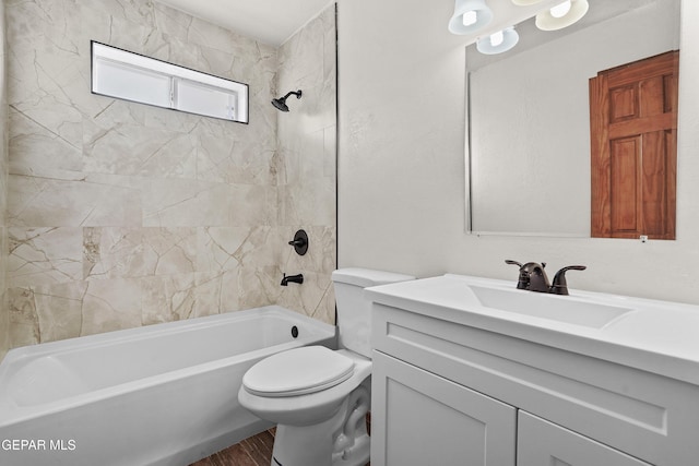 bathroom featuring wood finished floors, toilet, vanity, and washtub / shower combination