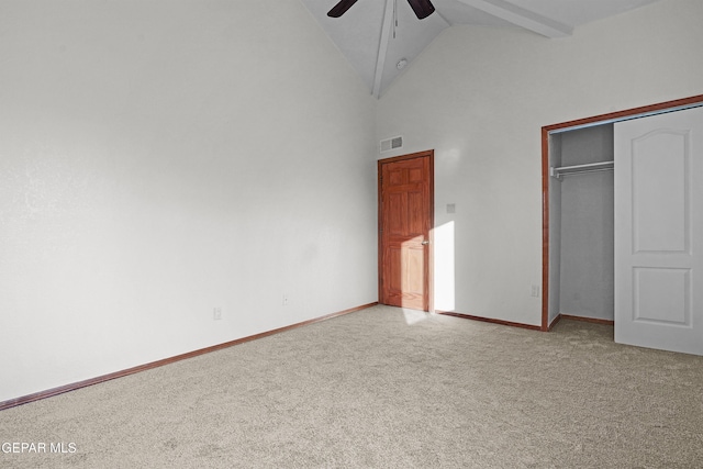 unfurnished bedroom with visible vents, baseboards, high vaulted ceiling, a closet, and light colored carpet