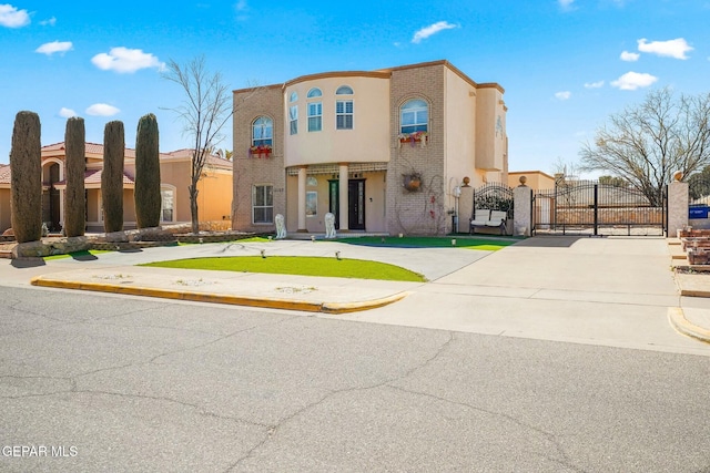 view of front of property featuring a gate and brick siding