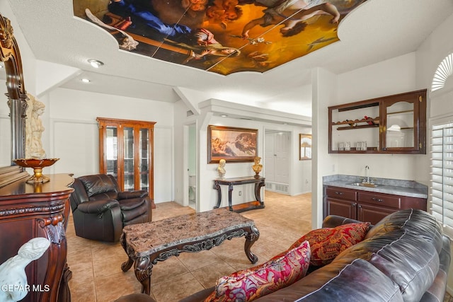 living area featuring indoor wet bar and light tile patterned flooring