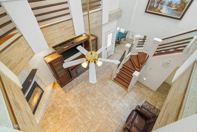 interior space with a high ceiling, stairway, and a fireplace