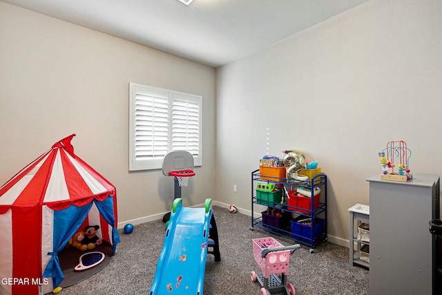 rec room featuring carpet flooring and baseboards