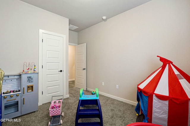 rec room with carpet, visible vents, and baseboards