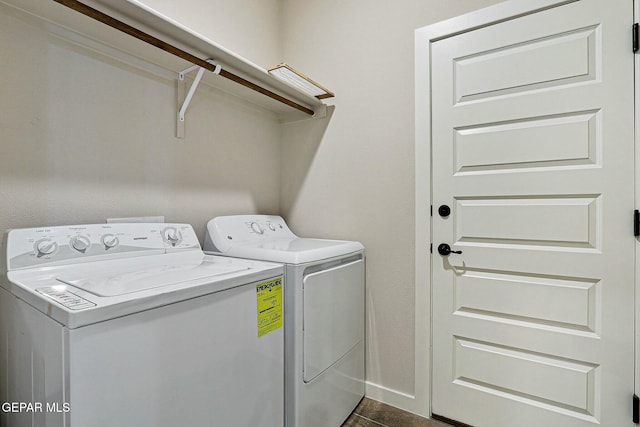 washroom with baseboards, laundry area, and washer and dryer