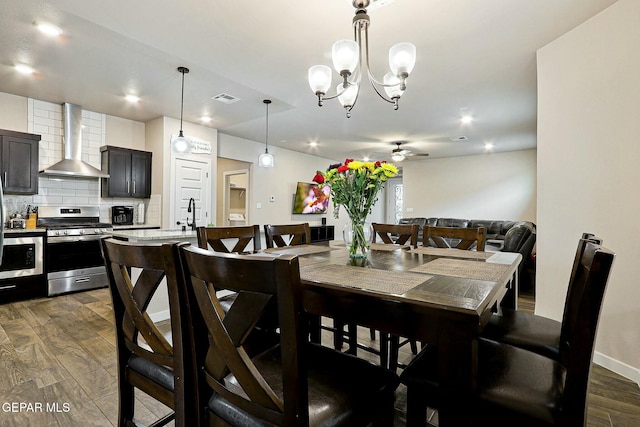 dining area featuring baseboards, visible vents, dark wood-style floors, ceiling fan with notable chandelier, and recessed lighting