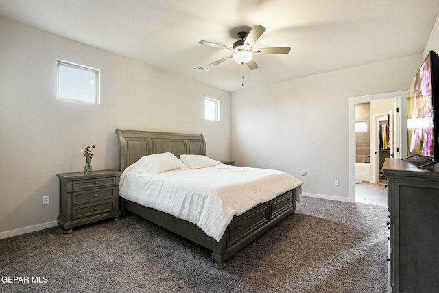 bedroom featuring visible vents, dark carpet, ensuite bathroom, ceiling fan, and baseboards