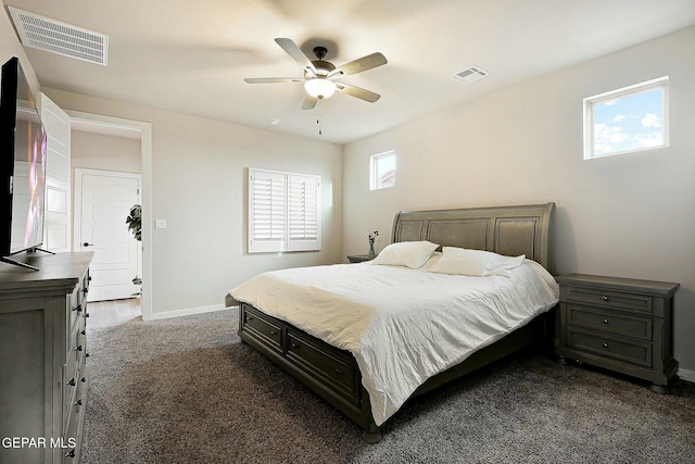 carpeted bedroom featuring a ceiling fan, visible vents, and baseboards