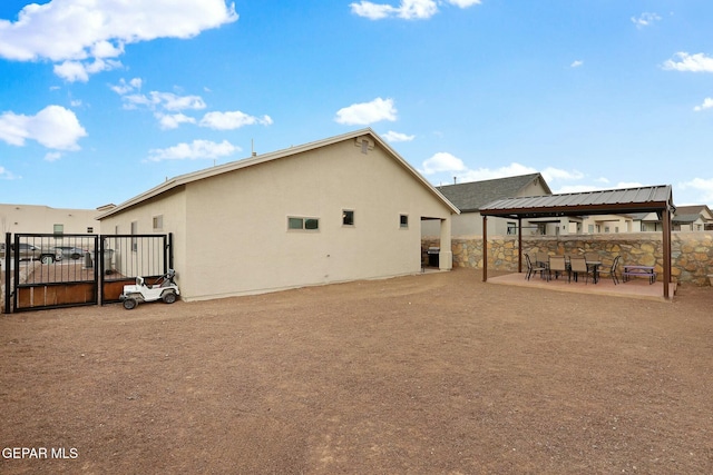 back of house with central AC unit, stucco siding, fence, and a patio