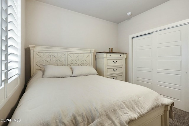 carpeted bedroom featuring a closet