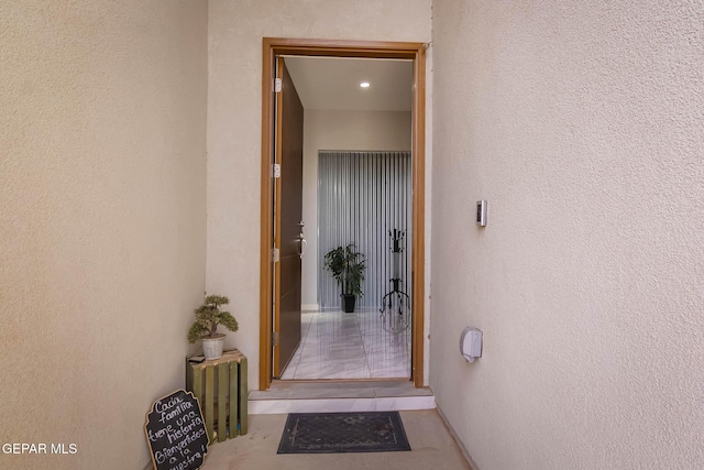 doorway to property featuring stucco siding