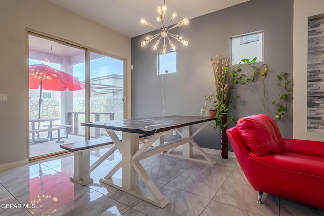 dining area featuring baseboards and an inviting chandelier