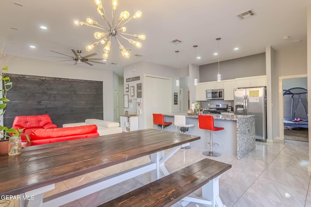 dining room featuring ceiling fan with notable chandelier, visible vents, and recessed lighting