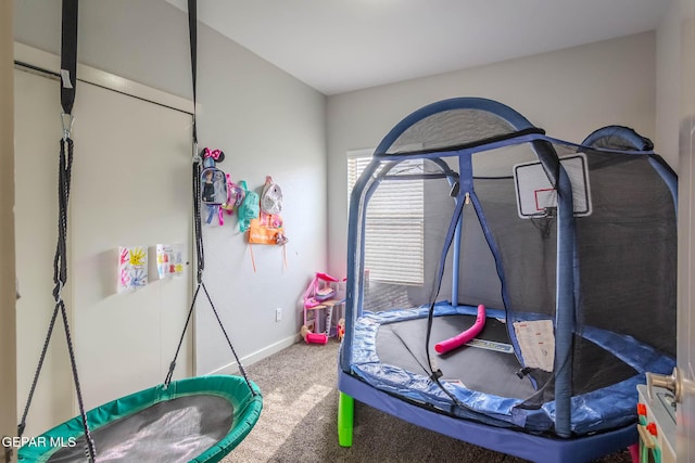 playroom with carpet floors and baseboards