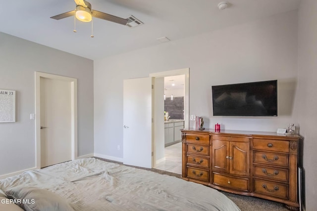 bedroom featuring ensuite bathroom, ceiling fan, visible vents, and baseboards