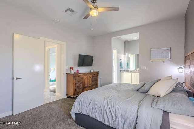 bedroom with ensuite bathroom, ceiling fan, carpet, and visible vents