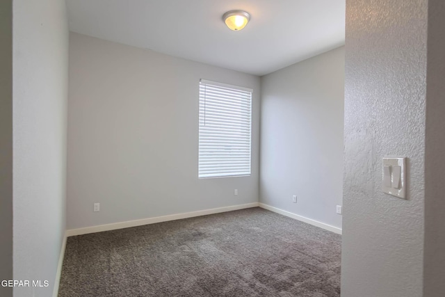 empty room with carpet flooring and baseboards